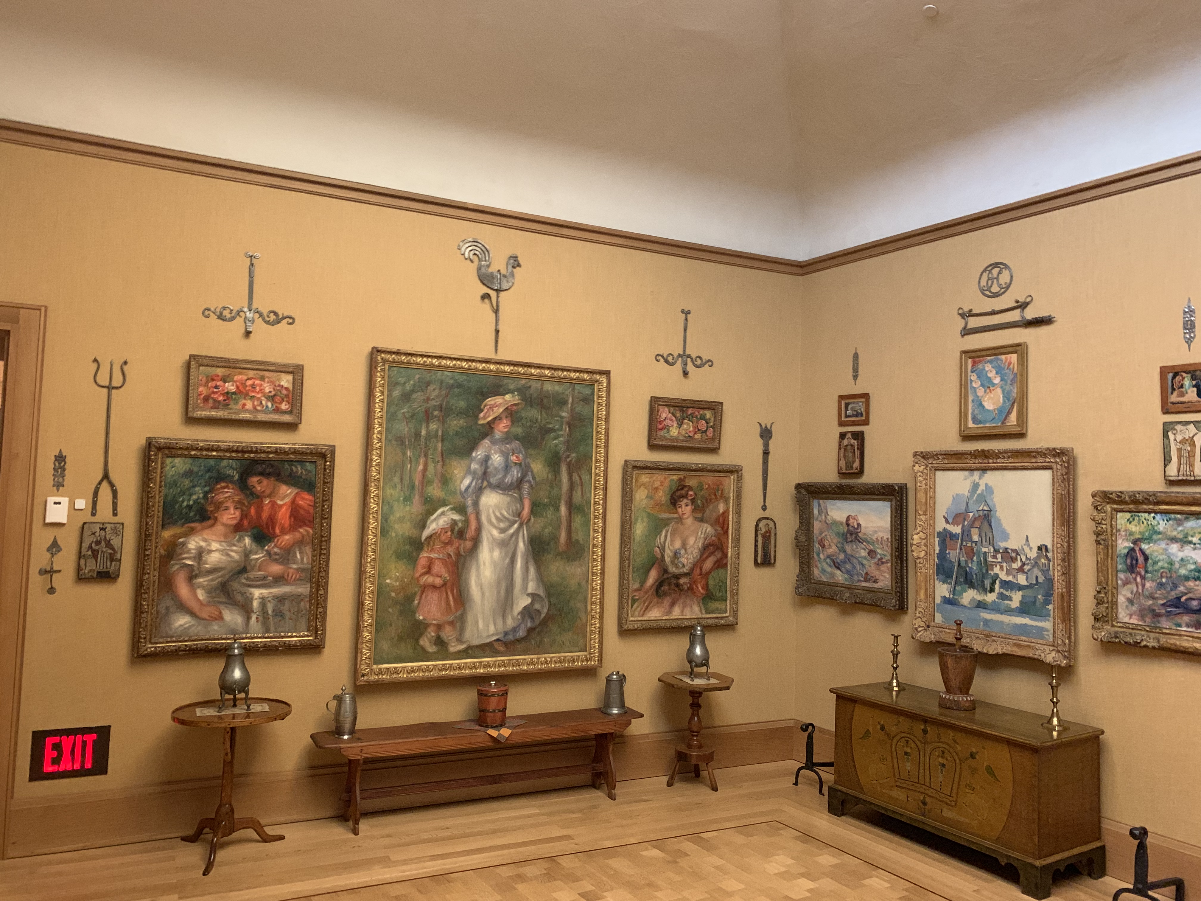 Interior view of the Barnes Foundation gallery with paintings and decorative elements.
