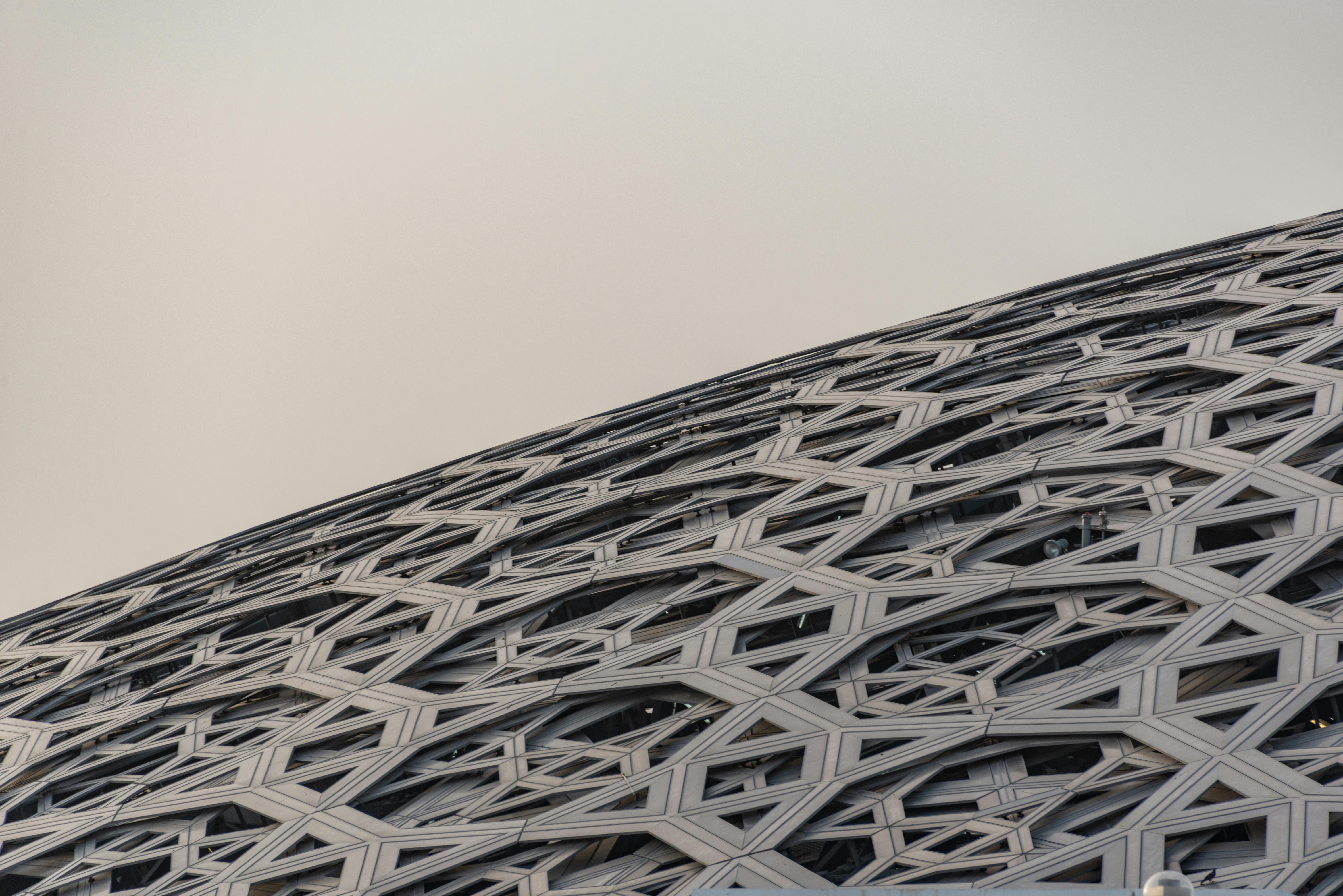 Close-up of the intricate geometric dome structure of the Louvre Abu Dhabi museum.