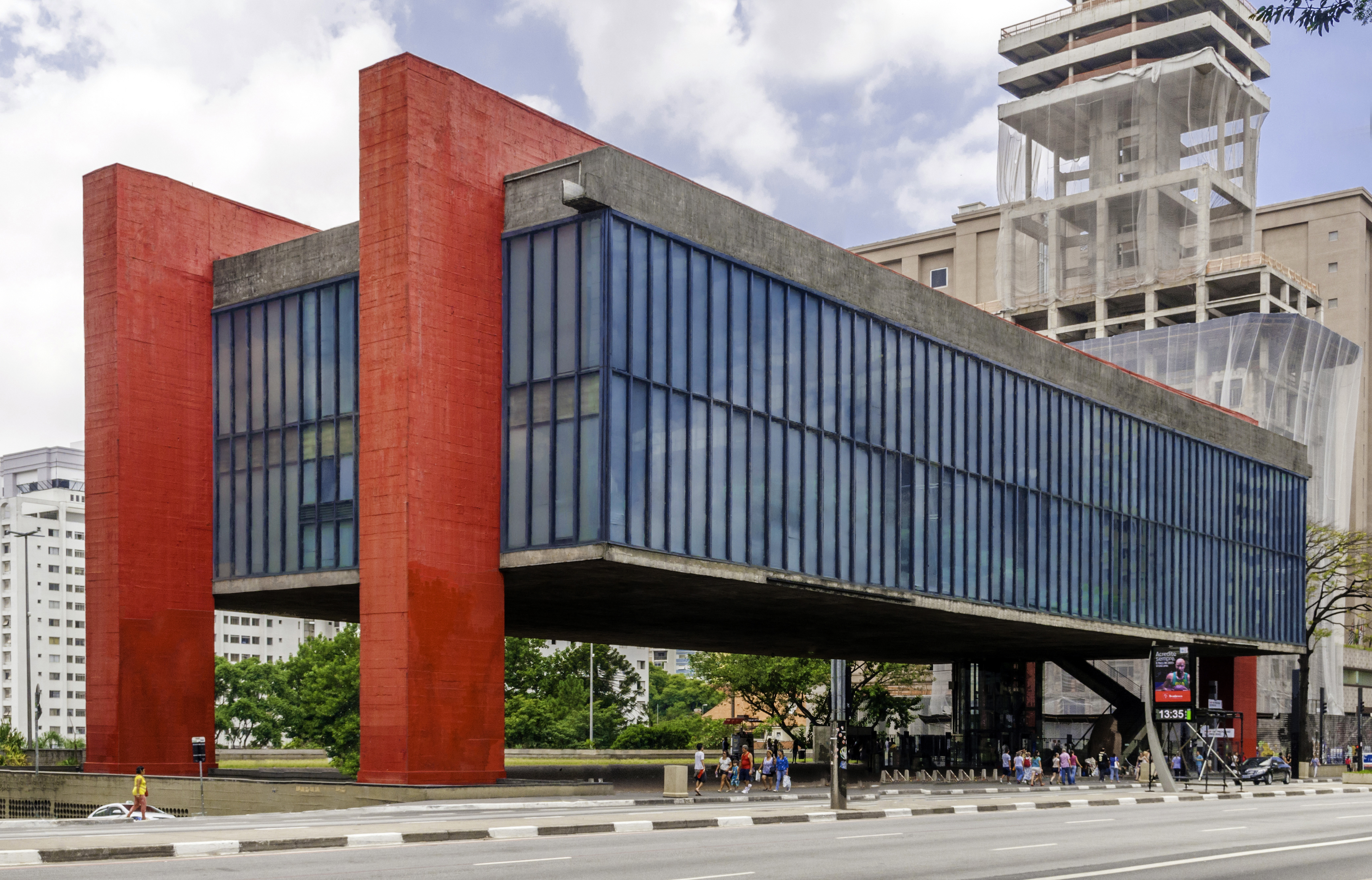 The iconic MASP museum in São Paulo, Brazil, featuring its distinctive red pillars and elevated glass structure.