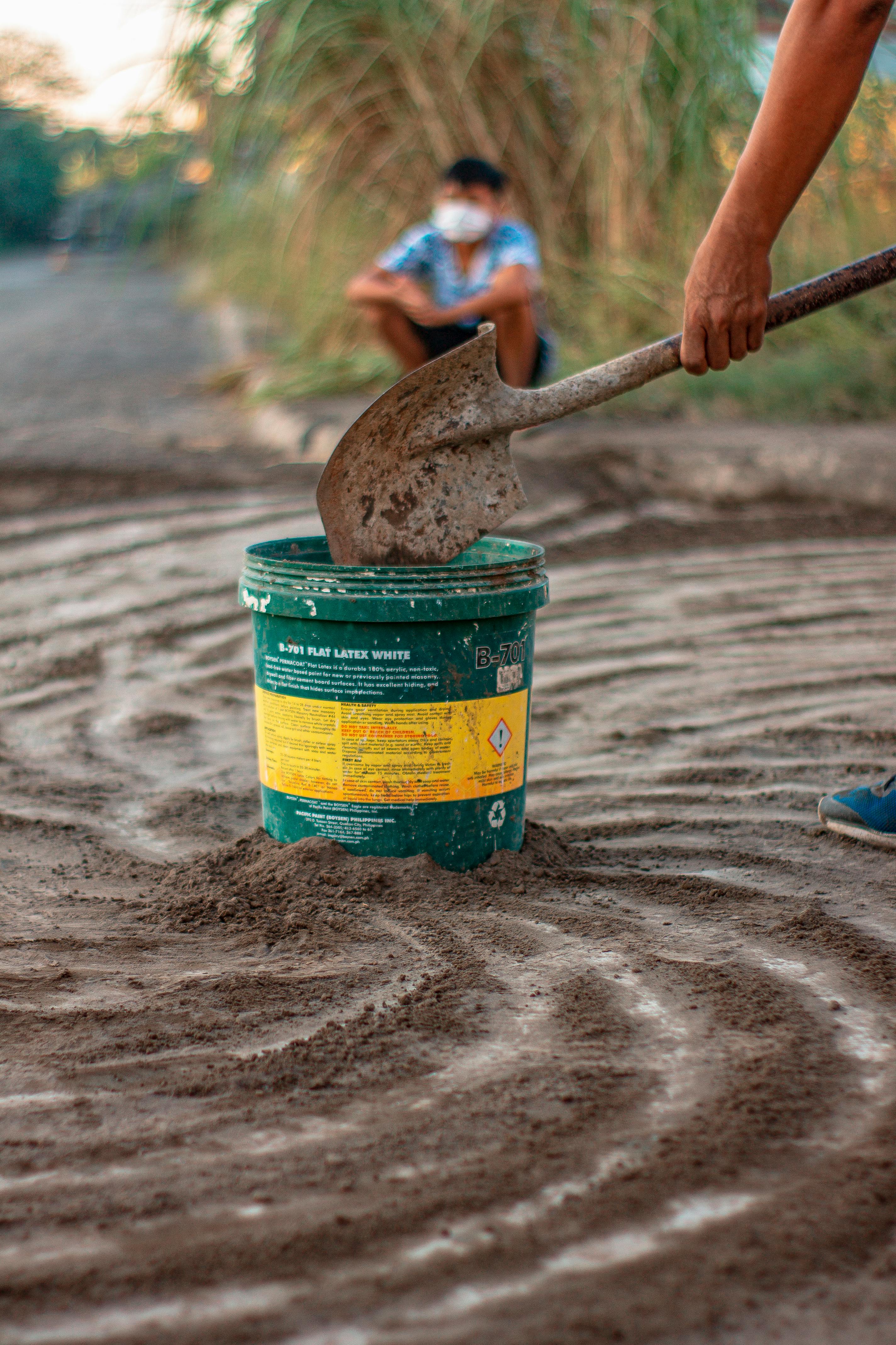 Yellow and Green Plastic Bucket with Hazard Warning and Shovel in Sand for Soil Treatment and Safety Compliance – DustBuster™ B-701 Model