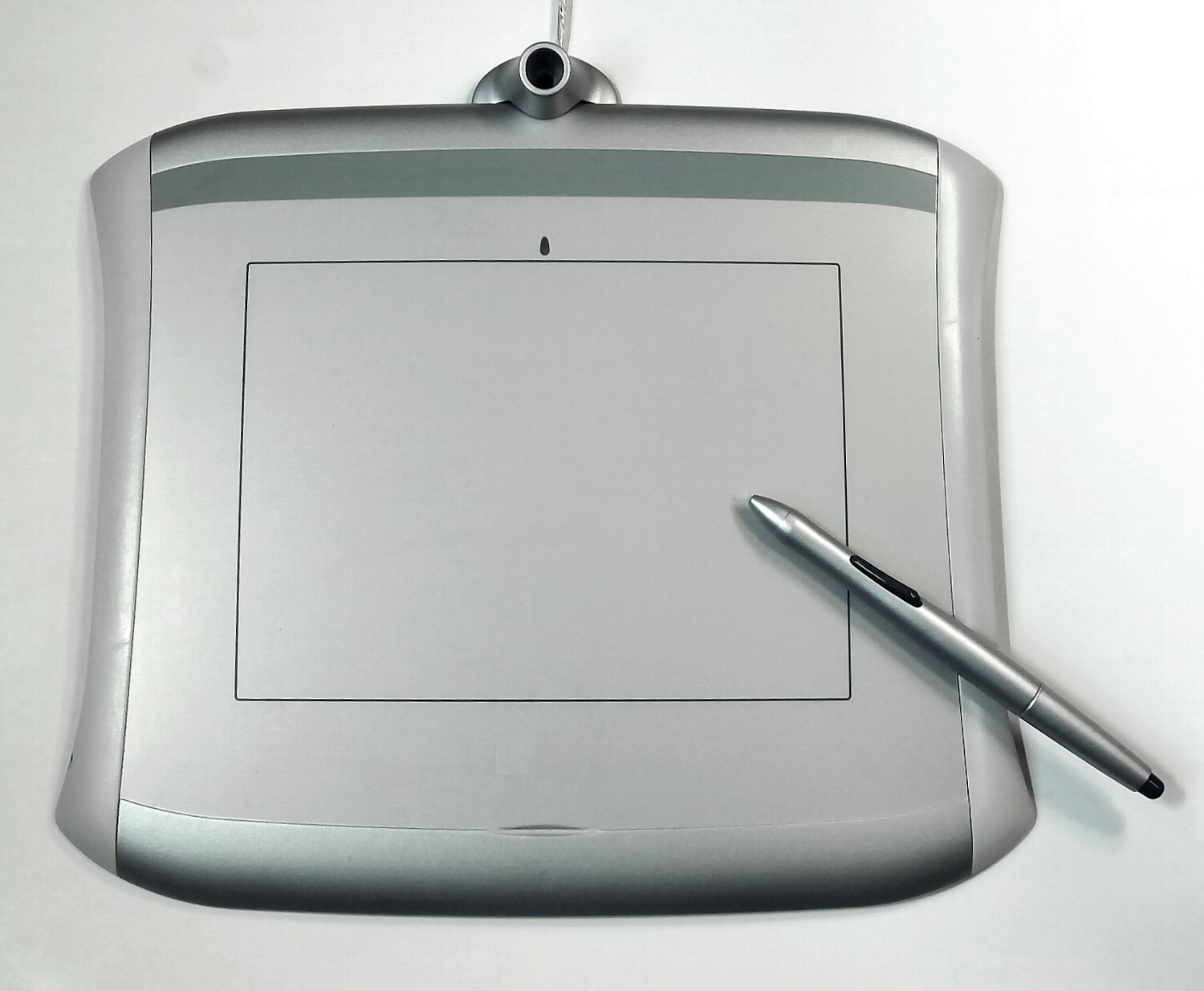Silver pen tablet with a stylus resting on its surface, ideal for beginners.