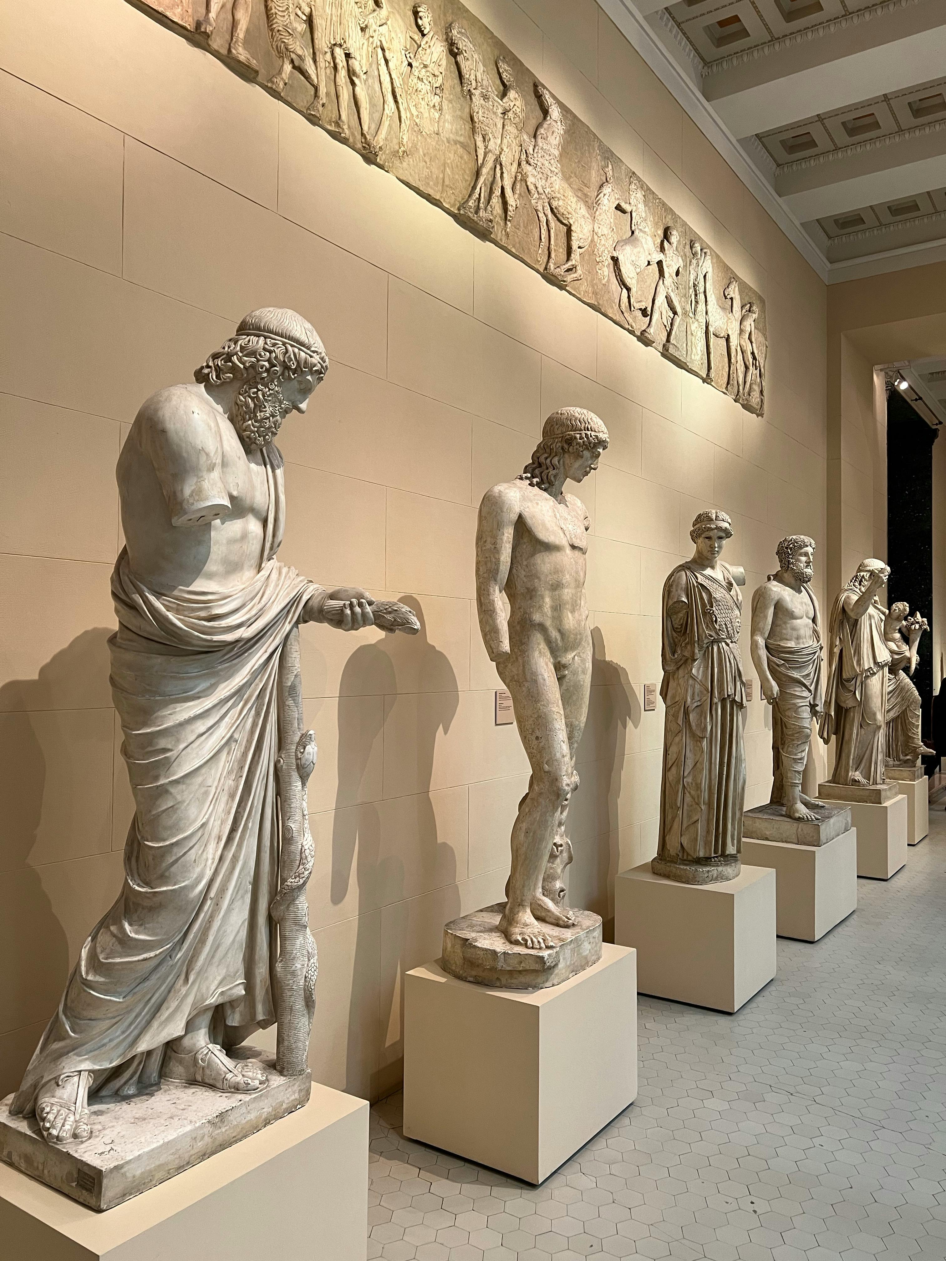 Ancient marble statues in a museum setting, showcasing timeless art with lasting appeal.