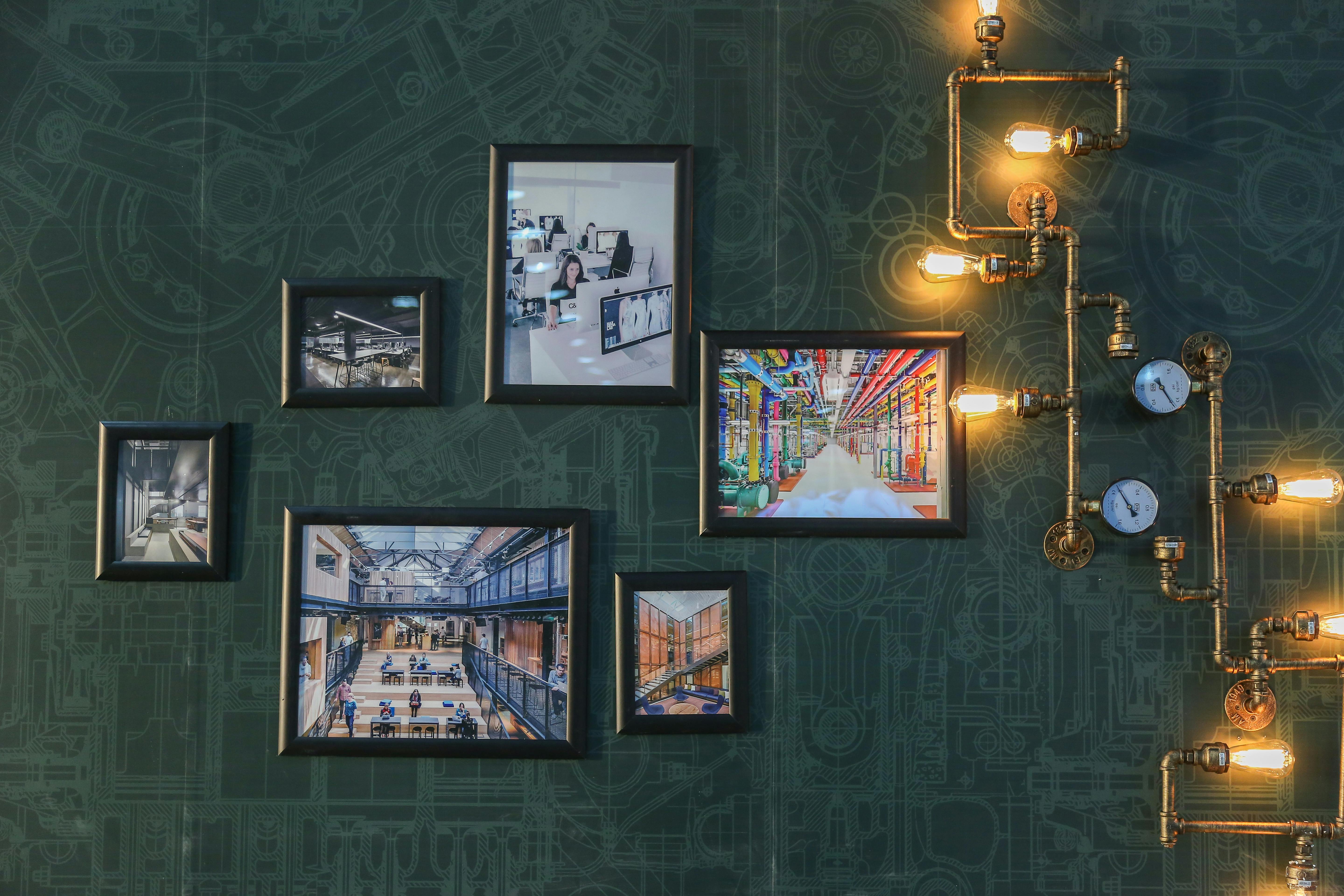 Green Wall Art with Framed Paintings and Industrial Lighting