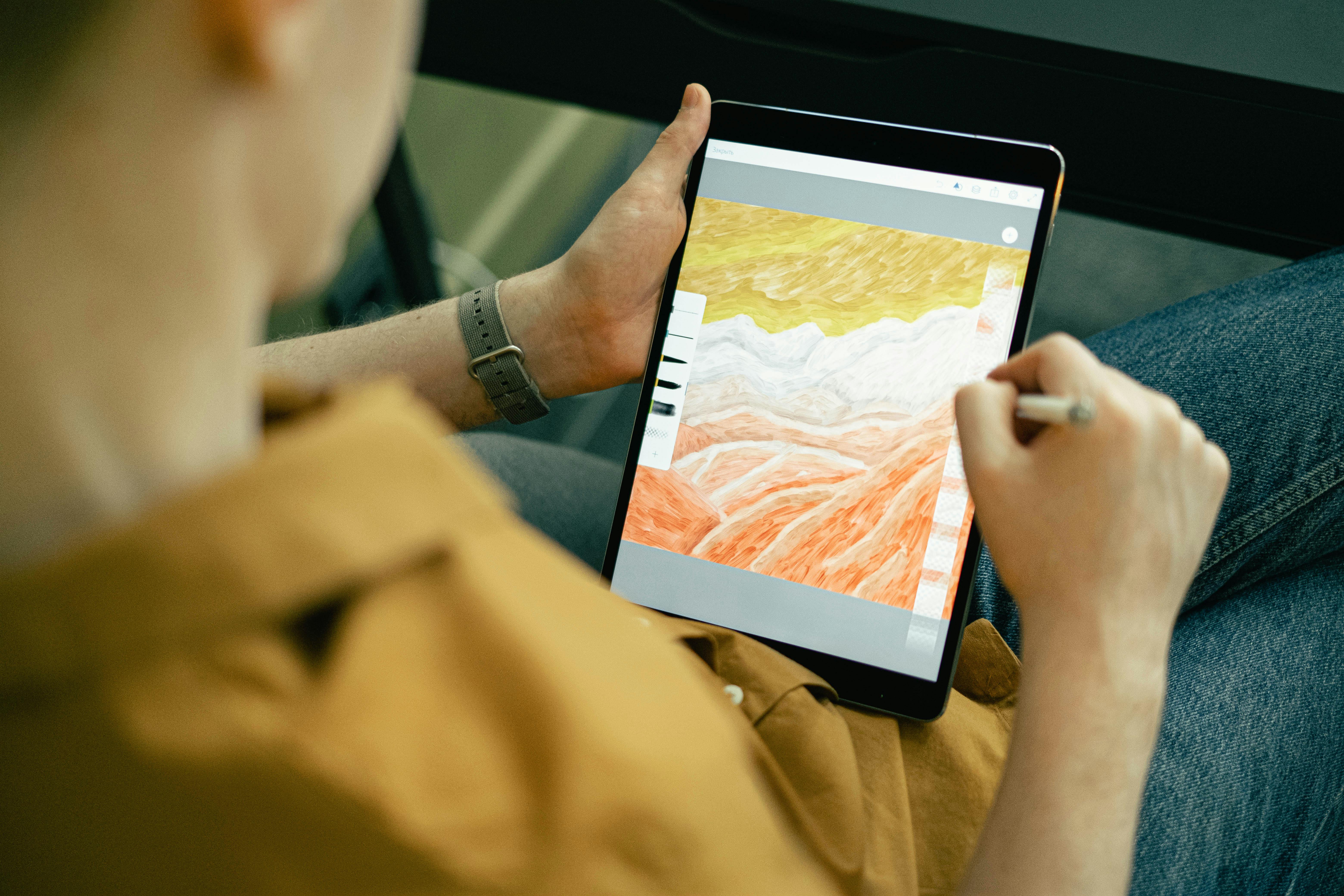 Person drawing abstract galaxy design on tablet with technical mastery in digital art.