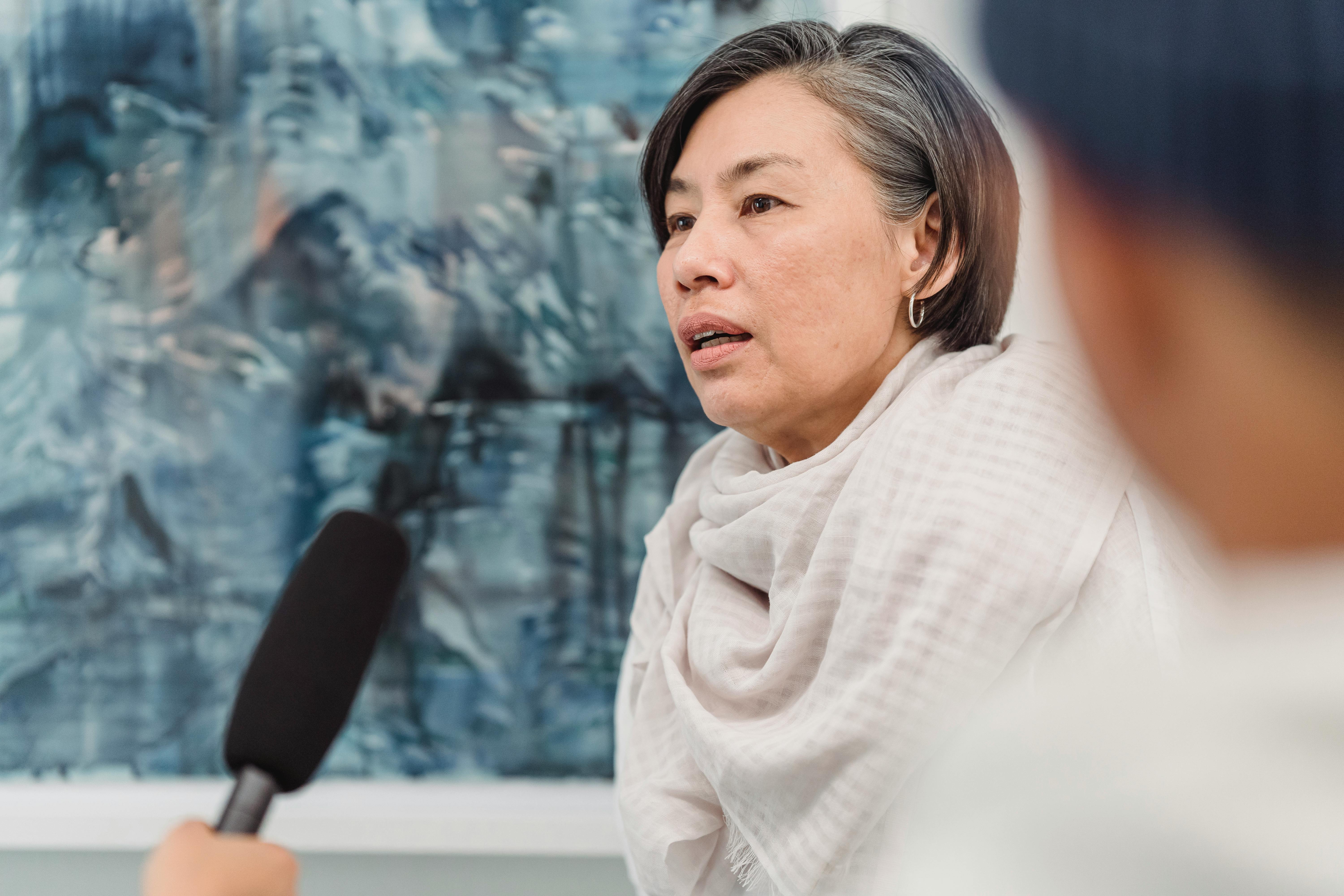 A-Woman-Being-Interviewed-in-Art-Gallery