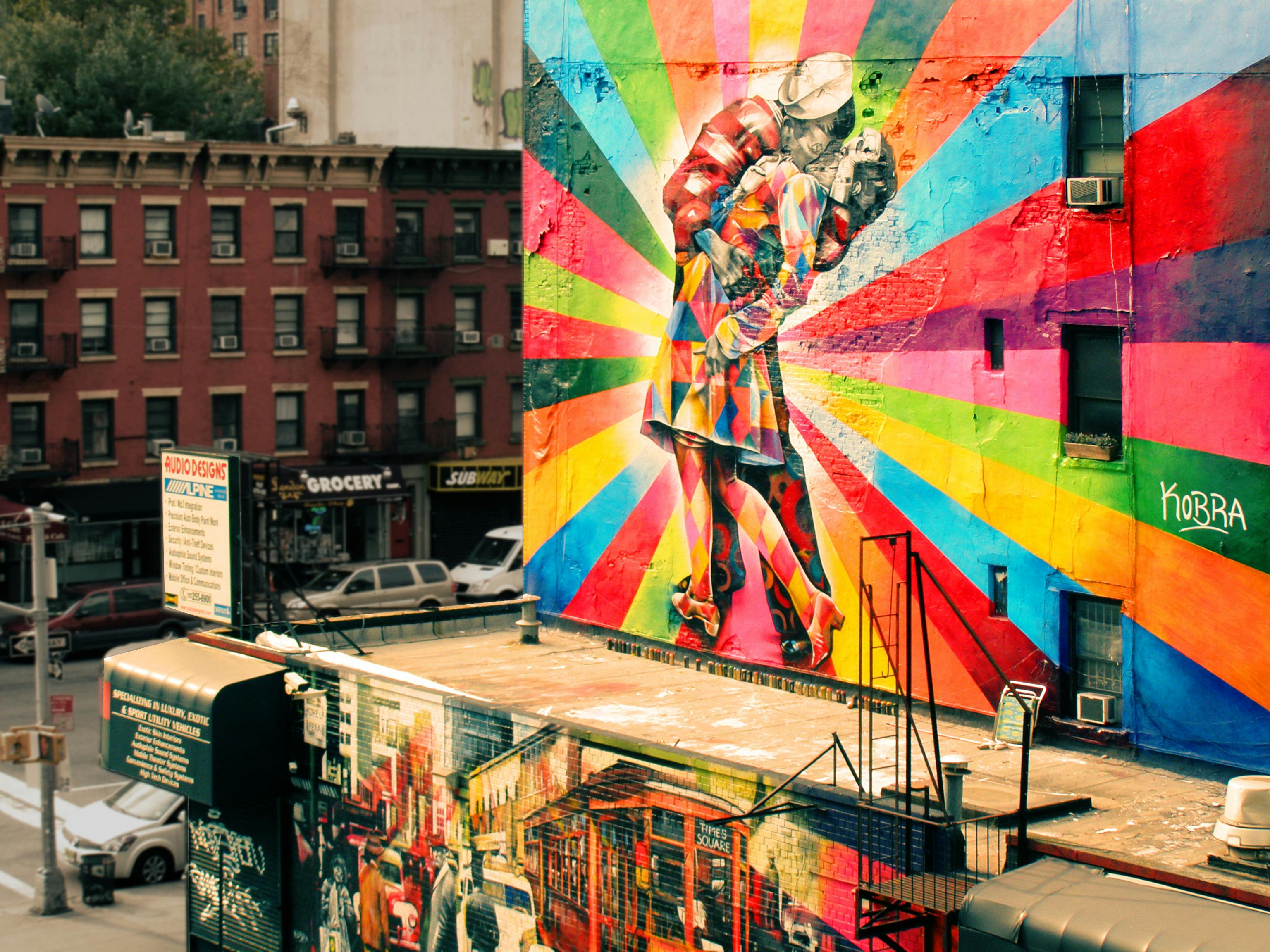 Vibrant rainbow-colored couple mural at Times Square for free public art enjoyment