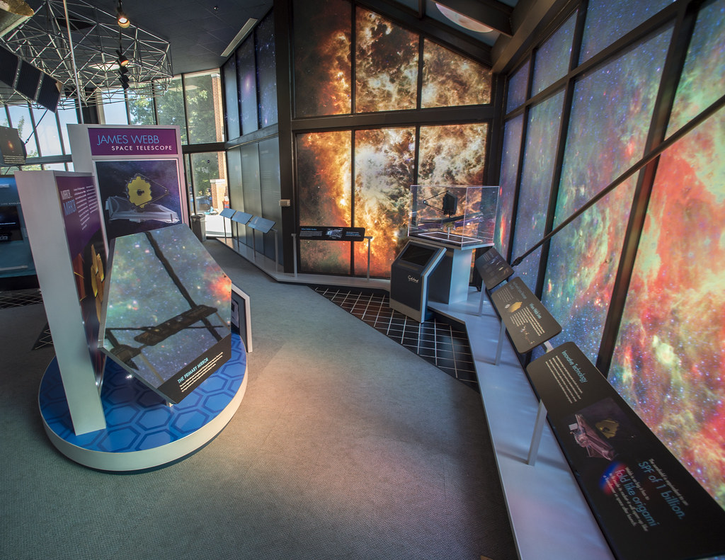 interactive exhibits in NASA Goddard Visitor Center showcasing space telescopes and research displays, including the James Webb Space Telescope model and educational panels about space technology and exploration