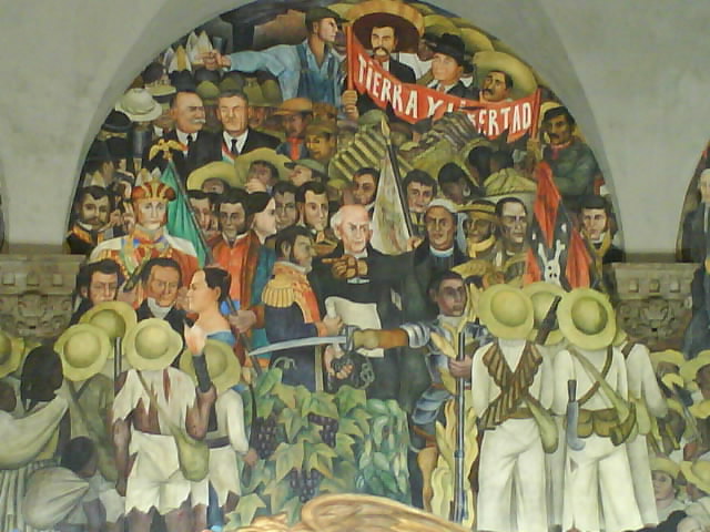 Diego Rivera's Mexican mural depicting revolutionaries and leaders during a social and political uprising, with a banner reading 'Tierra y Libertad'.