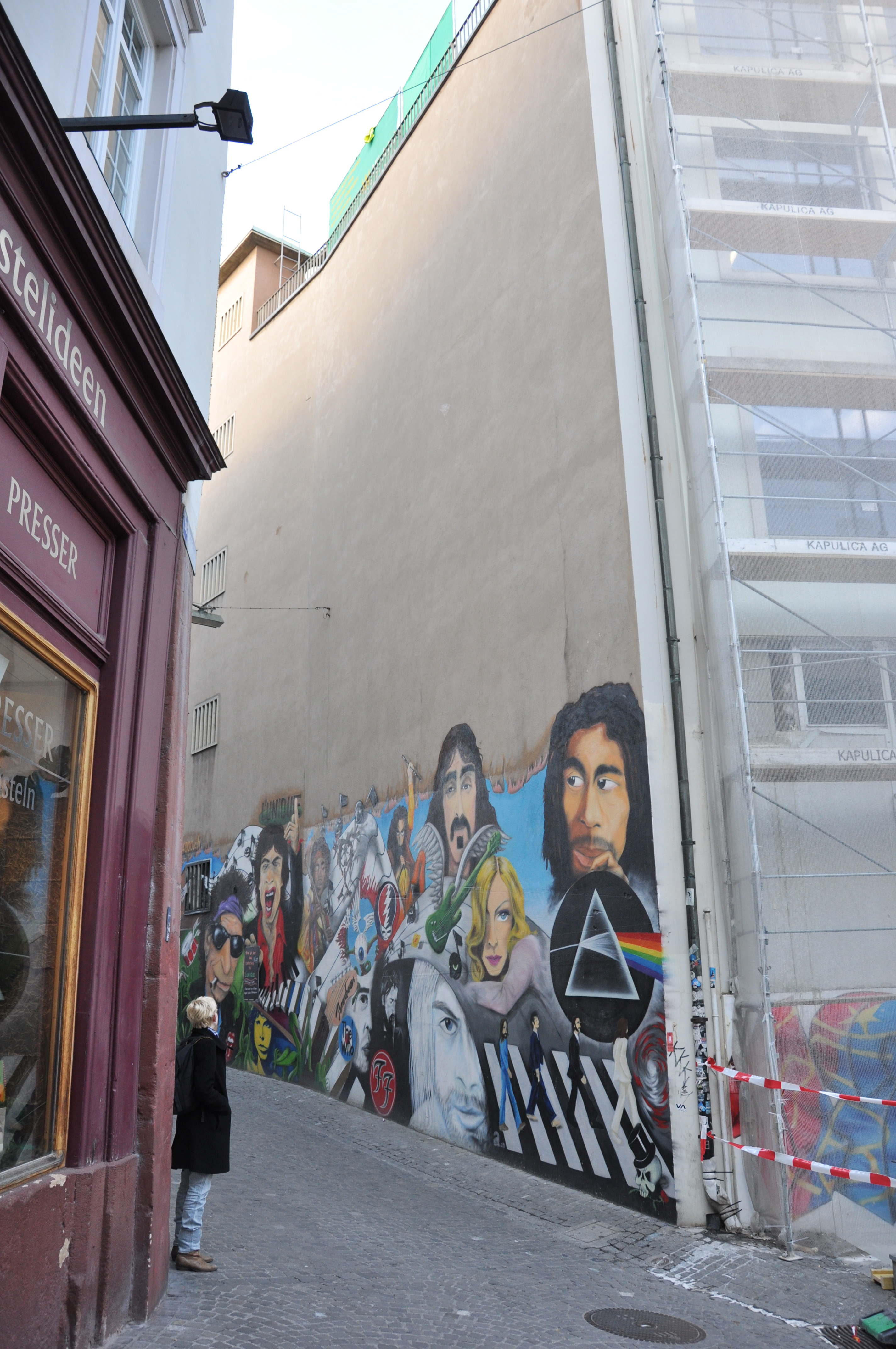 Street art mural featuring musicians and the Pink Floyd prism in Gerbergässlein, Basel, Switzerland.