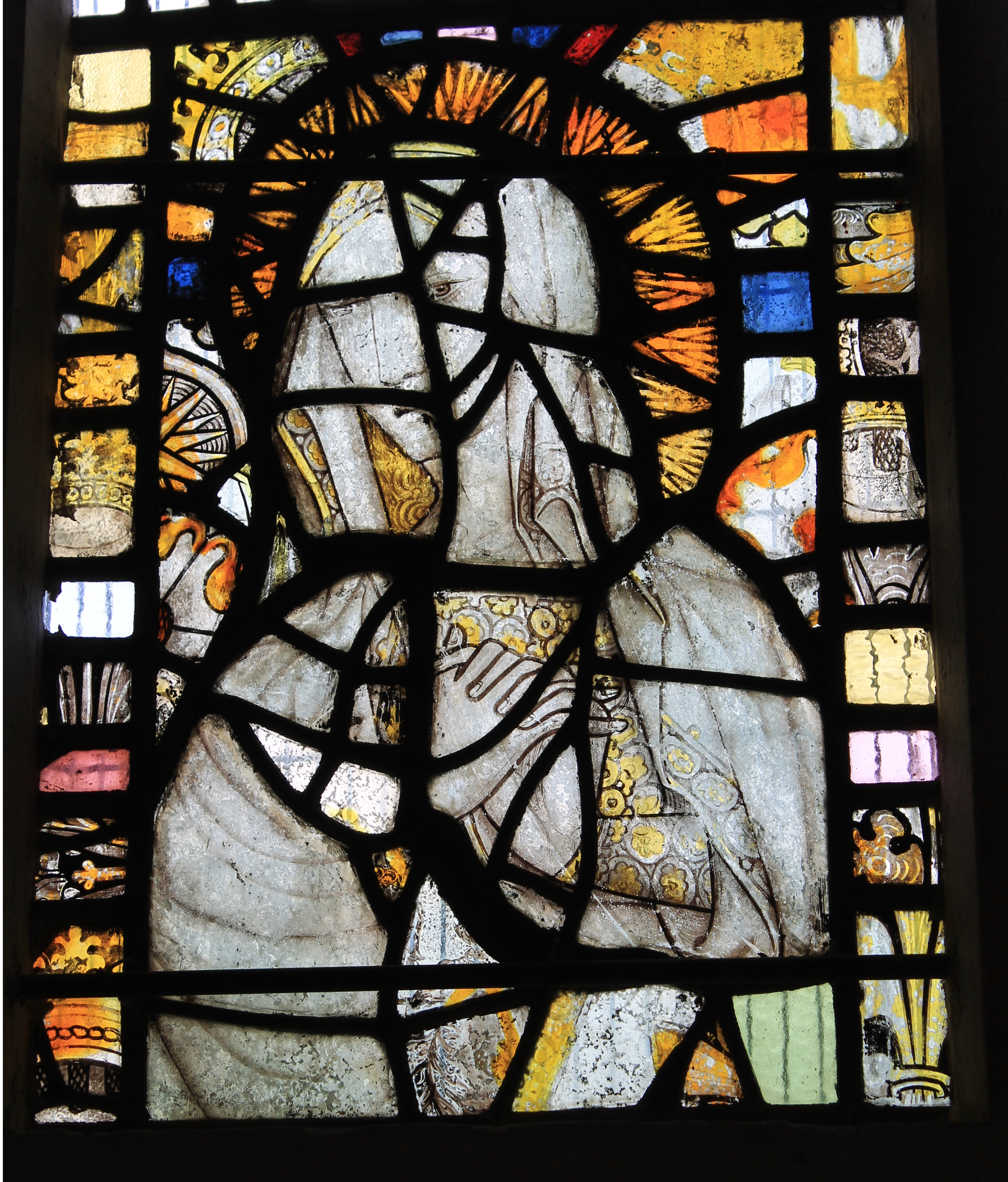 Medieval stained glass window depicting a figure with a halo and ornate robes, likely from Abbotsbury.