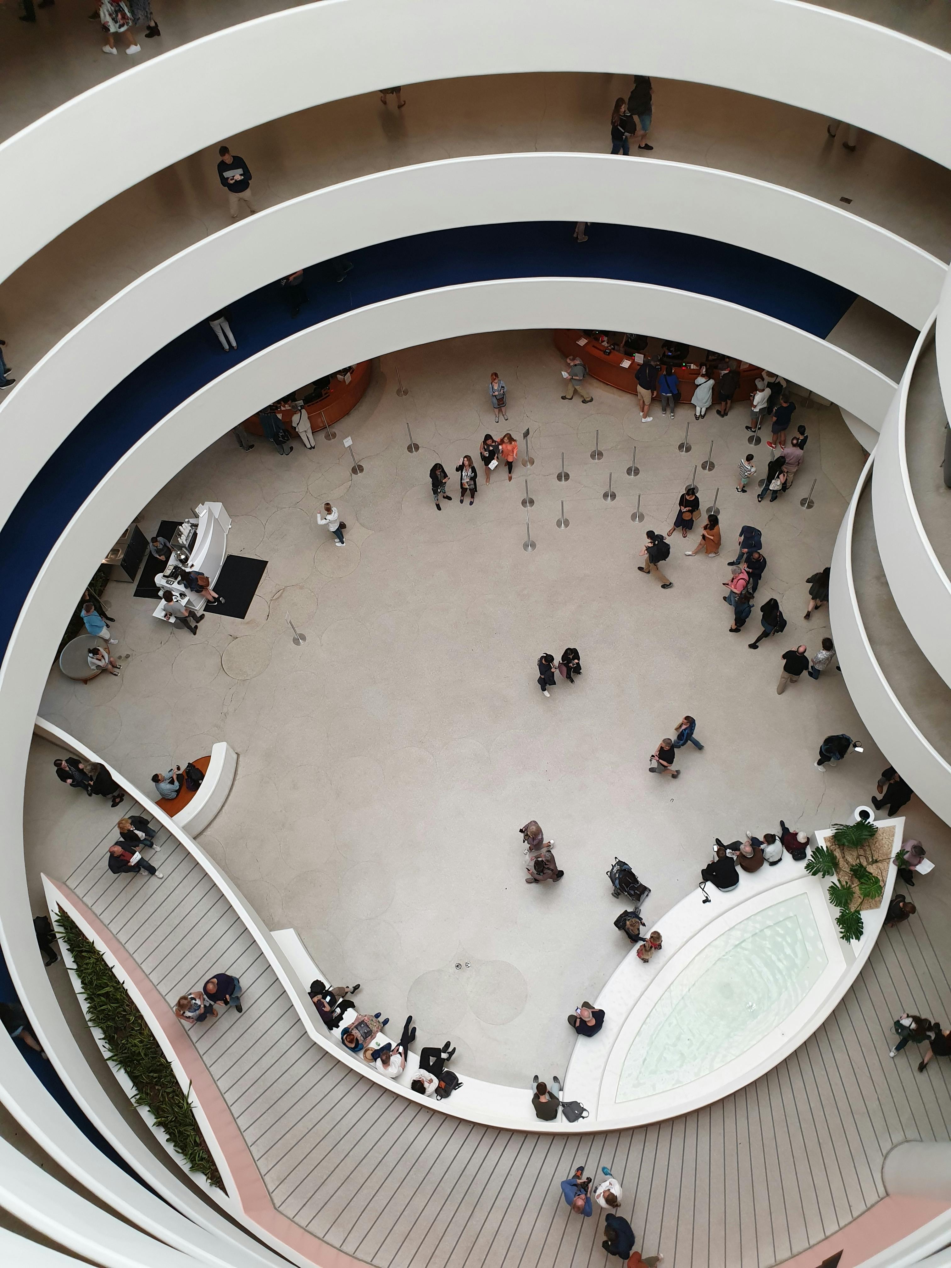 Interior view of the Guggenheim Museum of Art, highlighting the famous spiral staircase and modern architectural design, located on the Upper East Side of New York City. Visitors explore its unique circular layout and contemporary art exhibits. Frank Lloyd Wright’s iconic design, art exhibitions, and cultural landmarks are featured prominently in this high-quality photo of one of NYC’s most iconic institutions.