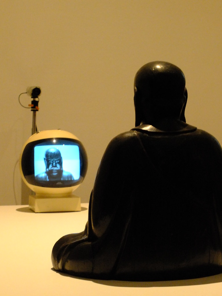 Nam June Paik's TV Buddha sculpture with a monitor displaying the sculpture's image.