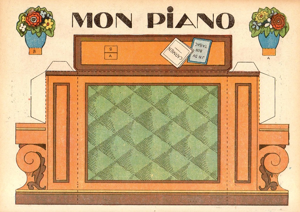 Vintage papercraft model of a piano with decorative flowers and sheet music elements.