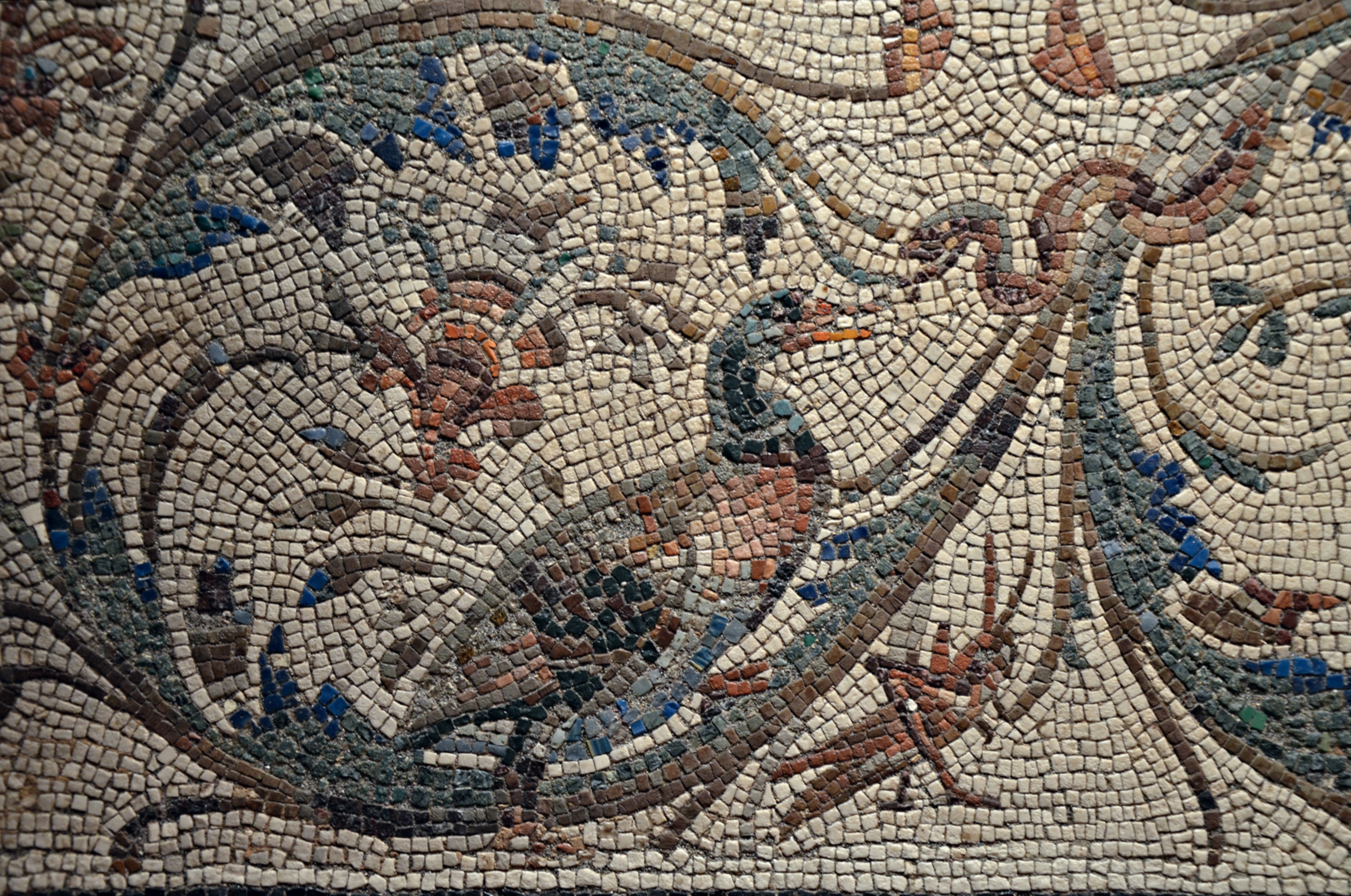 Mosaic border featuring acanthus spirals and various animals, including a prominent bird.