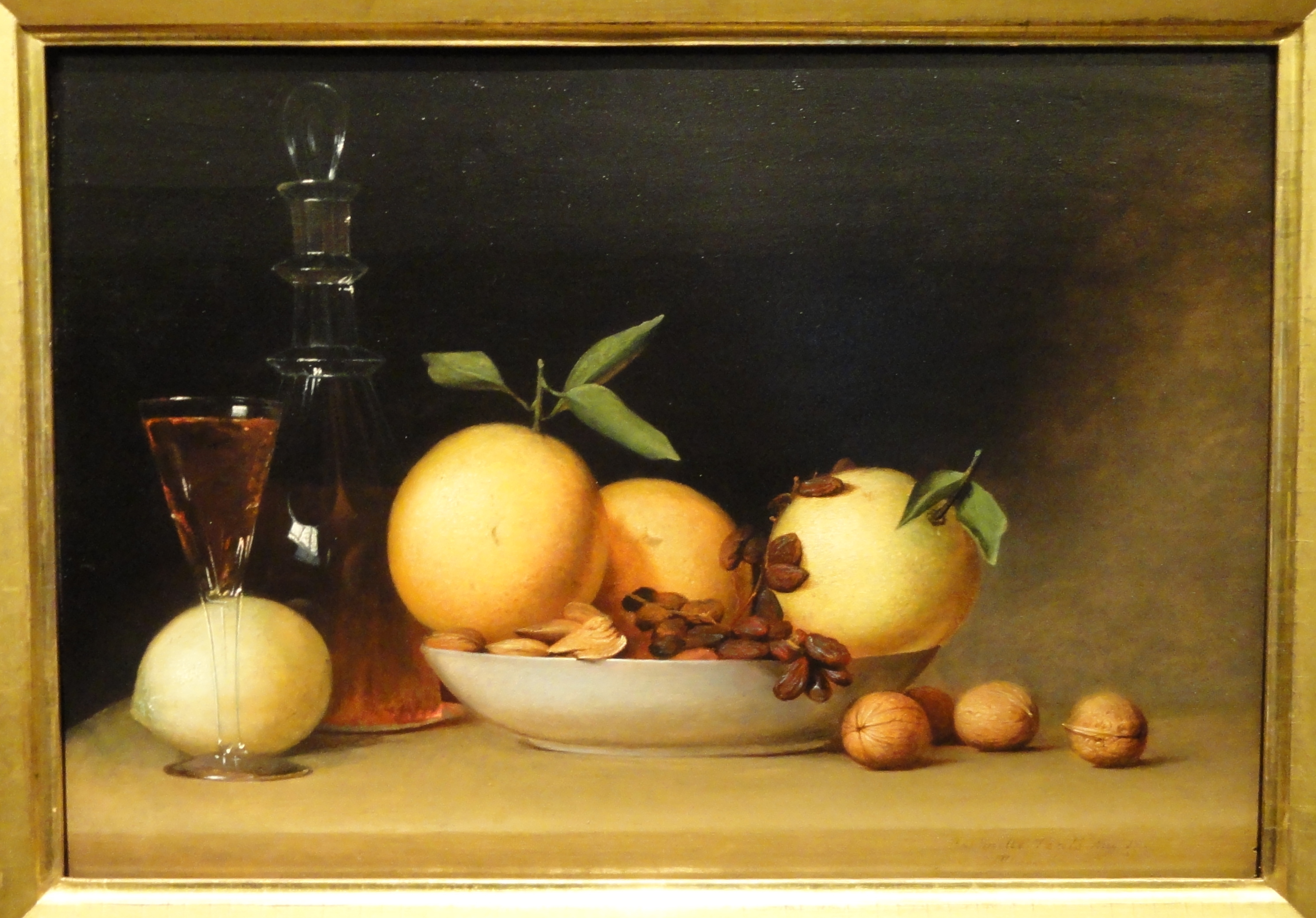 Still life painting of a decanter, a glass of red liquid, a bowl of nuts and fruit, and walnuts on a table, by Raphaelle Peale, 1814.