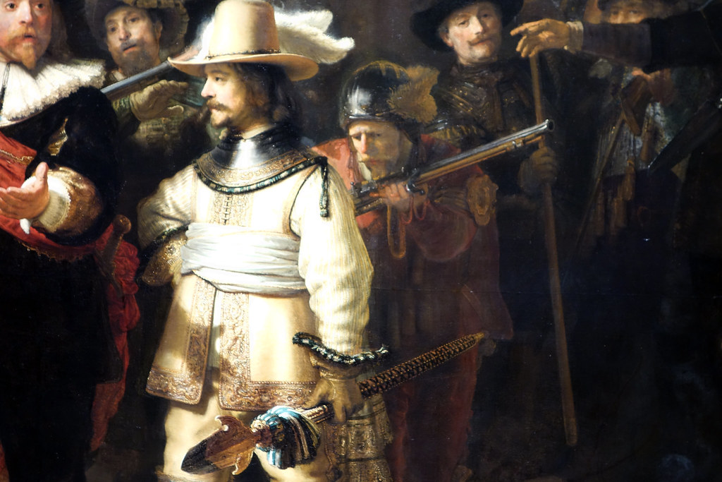 Rembrandt's The Night Watch group portrait showing a guard blowing out a pan in 17th-century Holland filling my close file