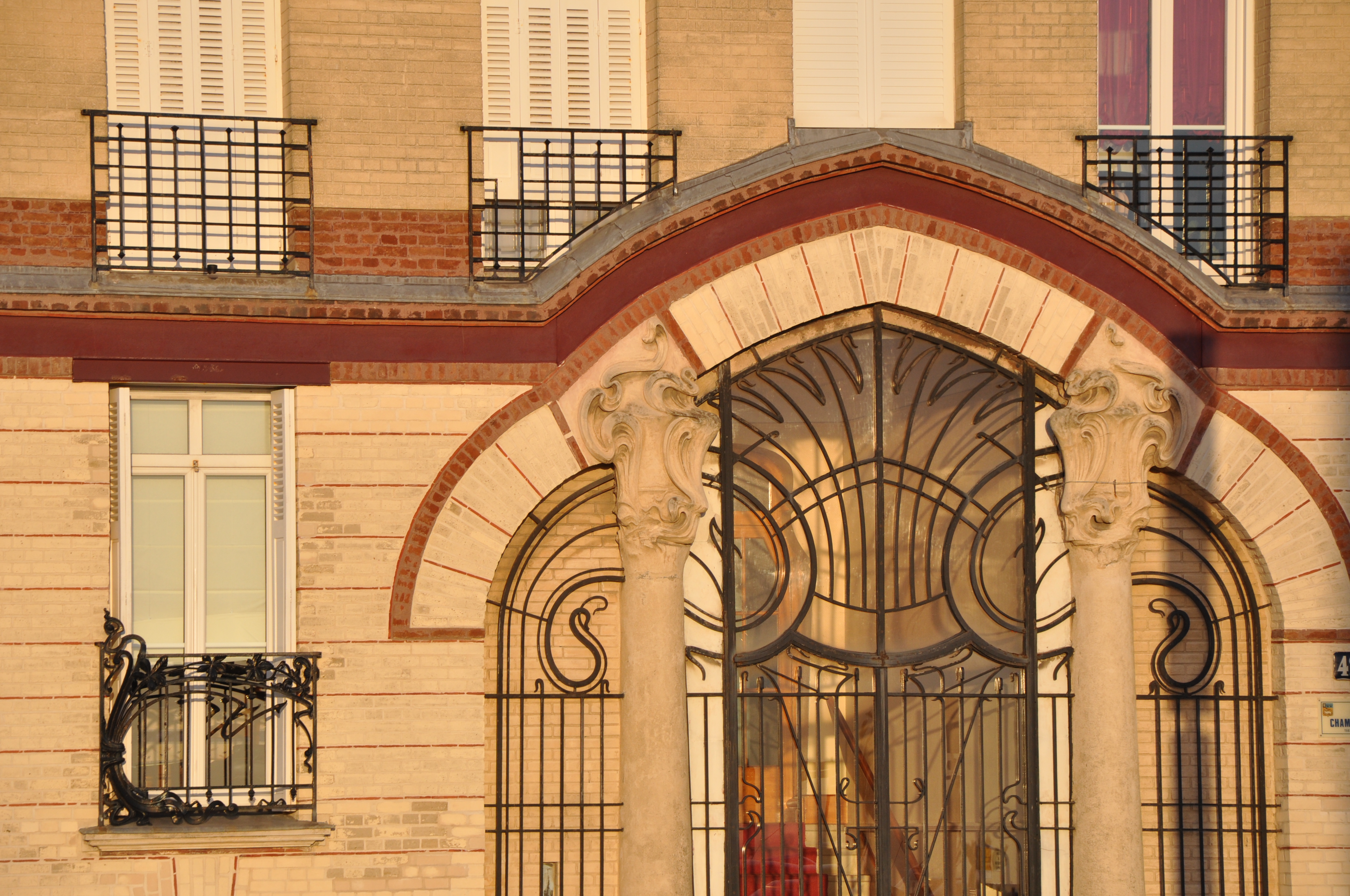 Art Nouveau facade in Le Havre, France, featuring ornate ironwork and decorative stonework.