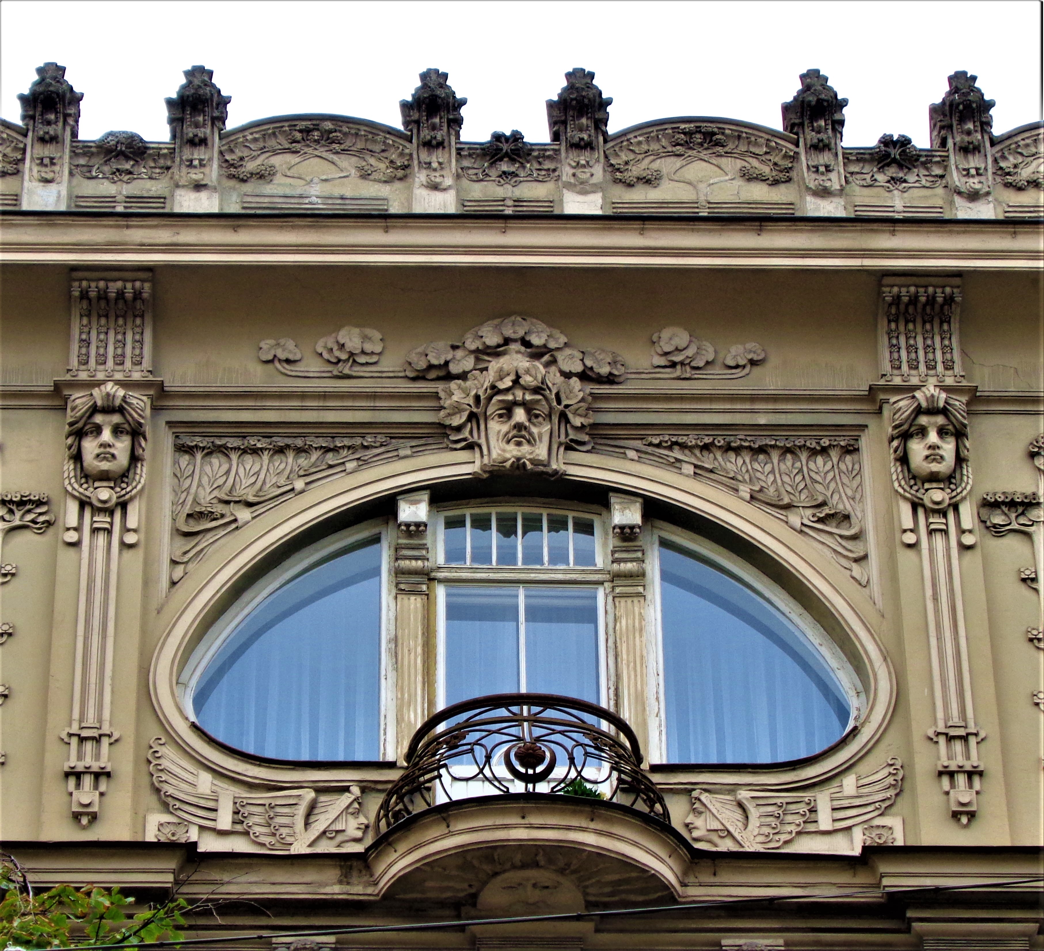 Art Nouveau facade in Riga with ornate details and a distinctive oval window