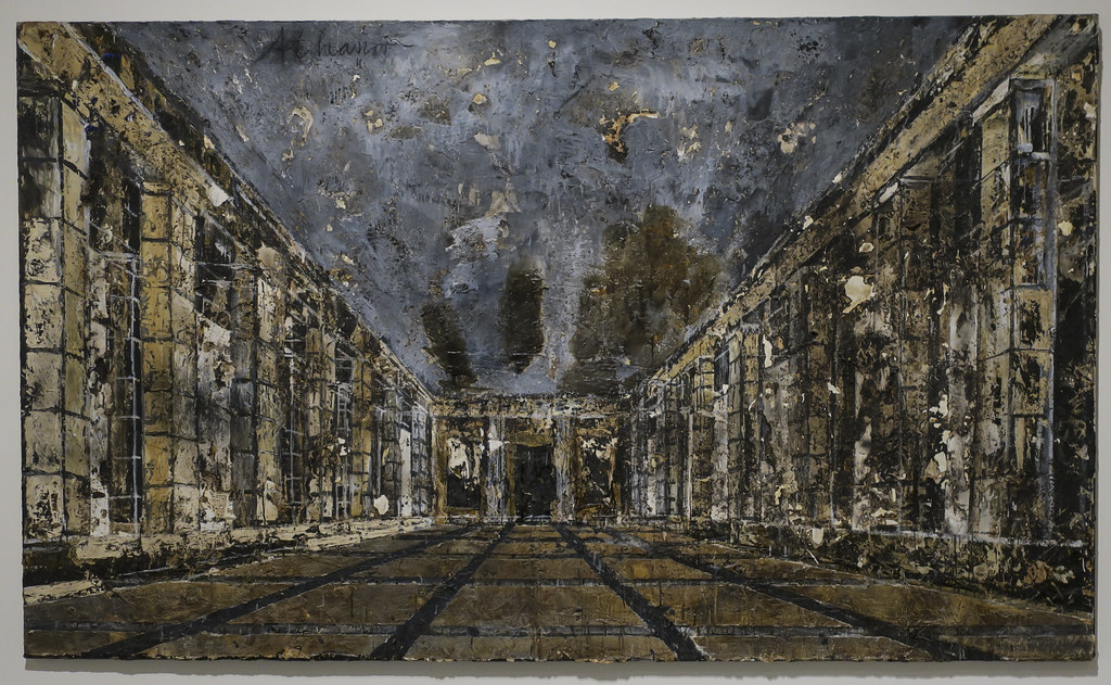 Anselm Kiefer painting depicting a long, dark, textured interior hall with columns and a gridded floor, characteristic of his monumental style.