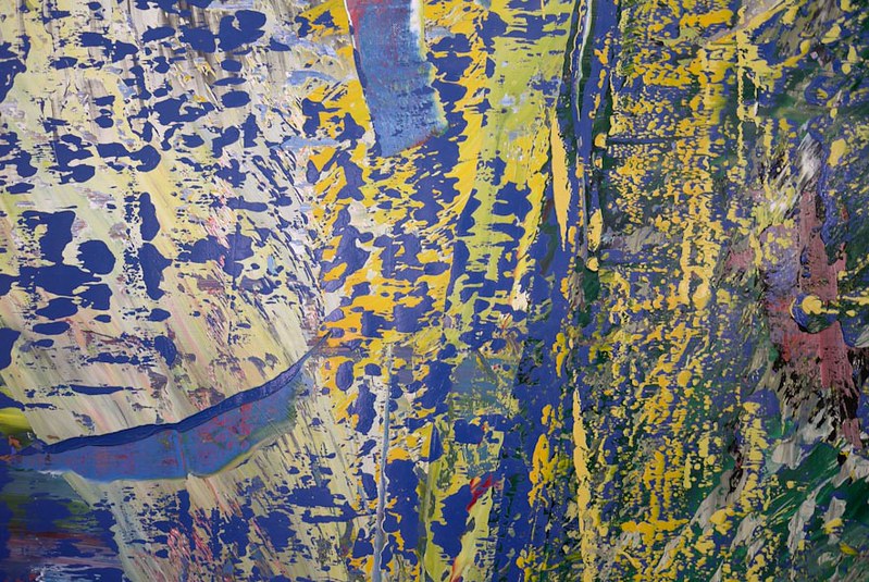 Detail of Gerhard Richter's Abstraktes Bild (1987), an abstract painting with vibrant blue, yellow, and green textured brushstrokes.