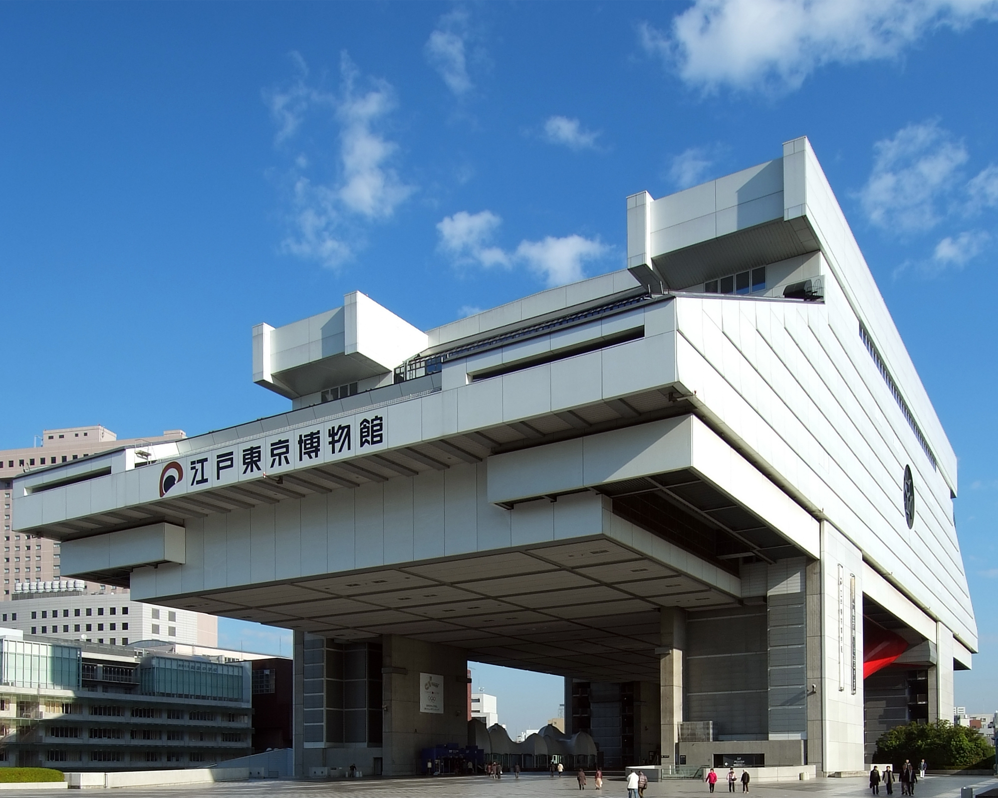 The Edo-Tokyo Museum, a large modern building with a distinctive elevated structure, under a clear blue sky.